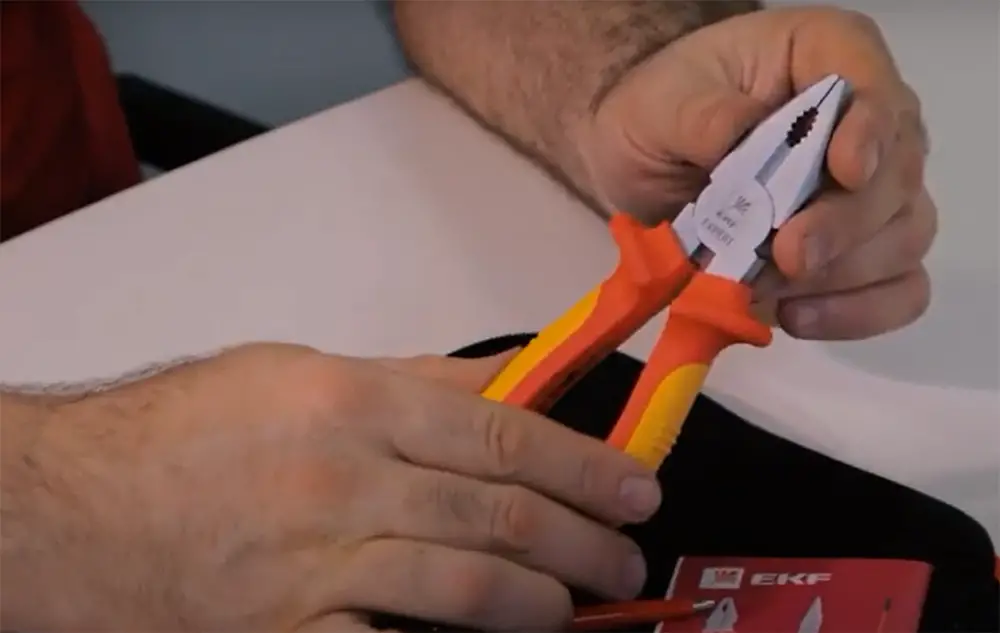 Use insulated pliers to hold the resistor in the middle